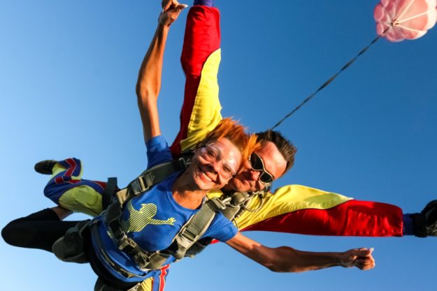 Tandem jump. The girl with the instructor in freefall.